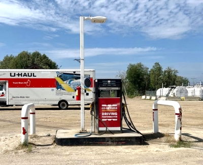 A gas bar that is no longer in service. Fuel holding tanks can be seen in the background, near the tree line of the property.