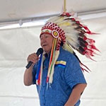 Chief Michael Starr standing with a microphone at the community event.