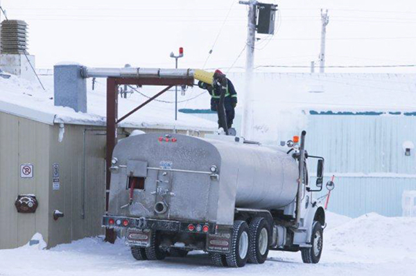 Operator filling a drinking water distribution truck